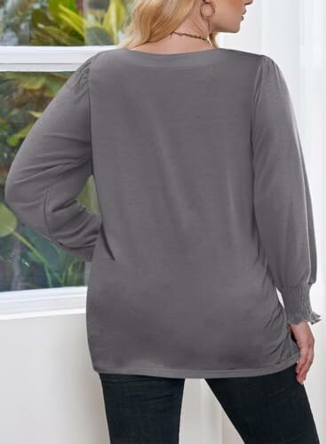 Back view of person wearing gray sweater