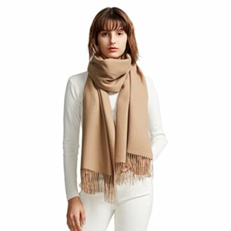 Woman wearing a beige scarf with fringe