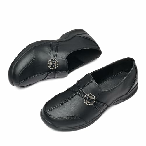 Black leather loafers with decorative buckles