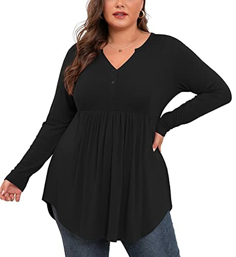 Woman wearing a black long sleeve tunic top with jeans.