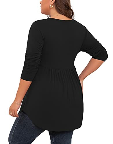 Woman wearing black long sleeve tunic with jeans