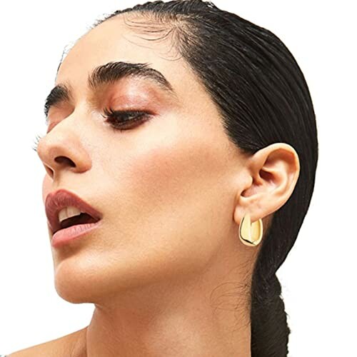 Woman wearing gold hoop earrings