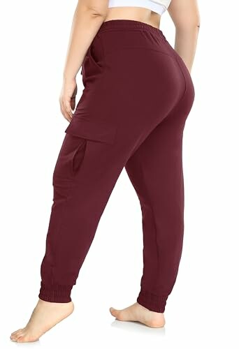 Back view of maroon jogger pants with cargo pocket.