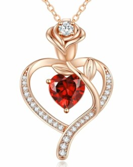 Rose gold heart pendant with red gem and diamonds.