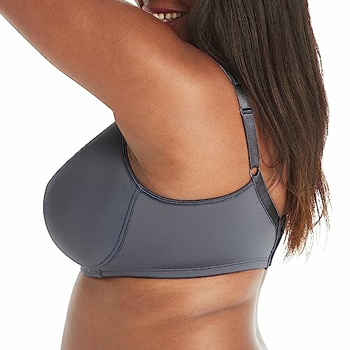 Side view of a woman wearing a gray bra.