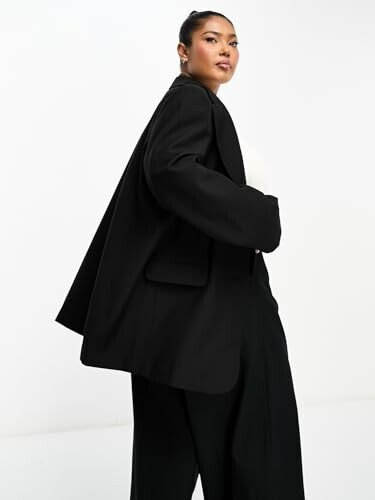 Woman wearing a black blazer with a confident pose