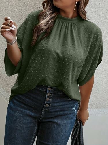 Woman wearing a green blouse and jeans.