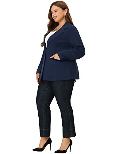 Woman wearing a navy blazer and dark jeans