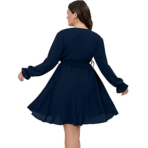 Woman in a navy long-sleeve dress, back view