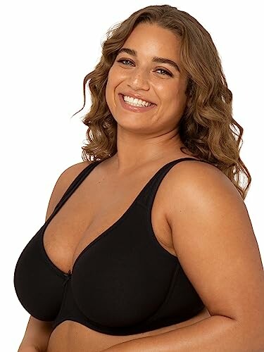 Smiling woman wearing a black bra.