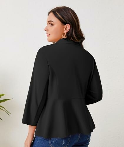 Woman wearing a black blazer, viewed from the back.