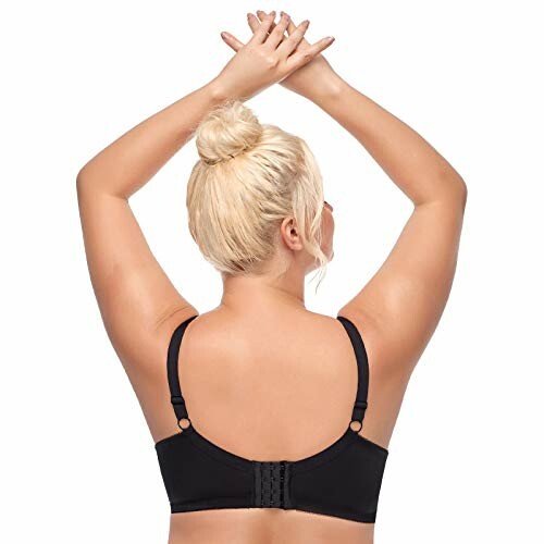 Back view of a woman wearing a black bra with hands raised.