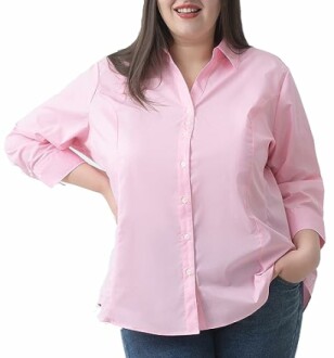 Woman wearing a button-down shirt in a stylish pose.