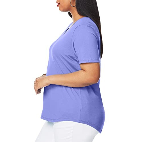 Side view of woman in purple t-shirt and white pants.